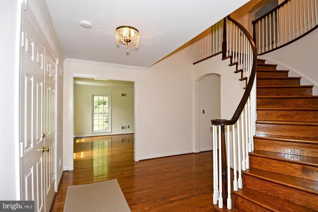 a view of an entryway with wooden floor and stairs