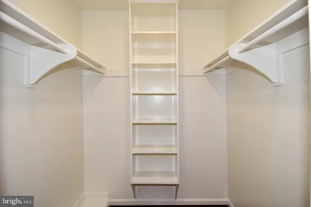 a view of a room with wooden floor and a window