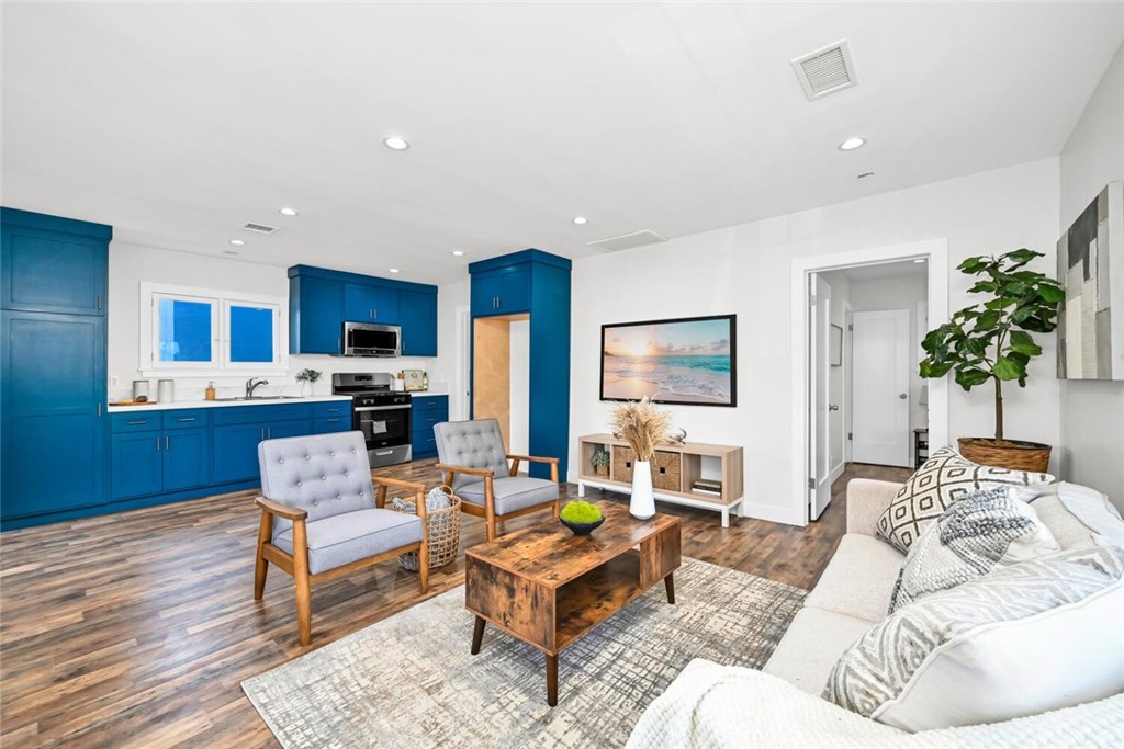 294 Bella Vista Avenue Pasadena, CA 91107 - Photo 11 of 37 a living room with furniture and a dining area with kitchen view