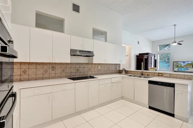 a kitchen with white cabinets and a stove