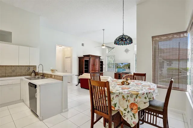 a kitchen with kitchen island a sink appliances and a counter top space