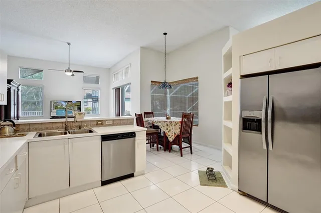 a kitchen with kitchen island granite countertop a sink and a stove