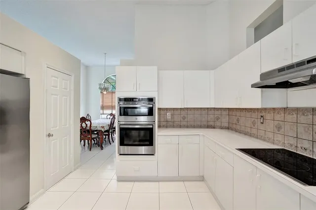 a dining room with furniture wooden floor and a chandelier