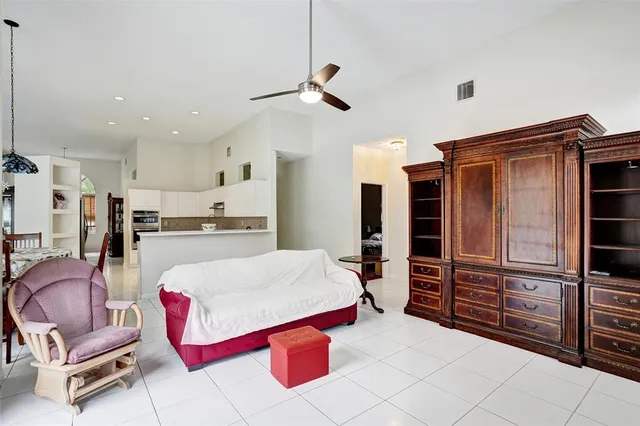 a living room with stainless steel appliances kitchen island granite countertop furniture and a view of kitchen