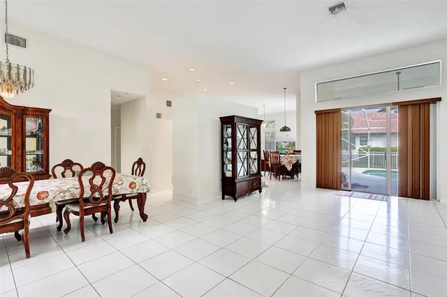 a living room with furniture a dining table and chairs
