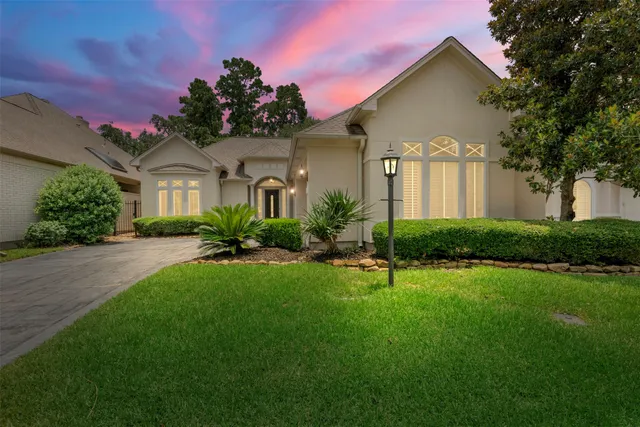 a front view of a house with a garden and plants