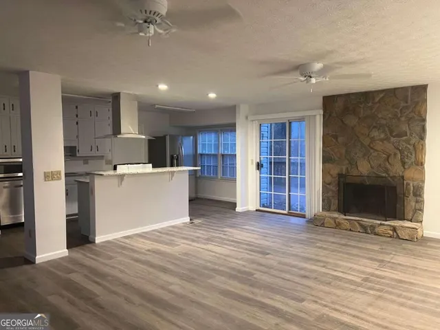 a view of a kitchen with a sink and a refrigerator