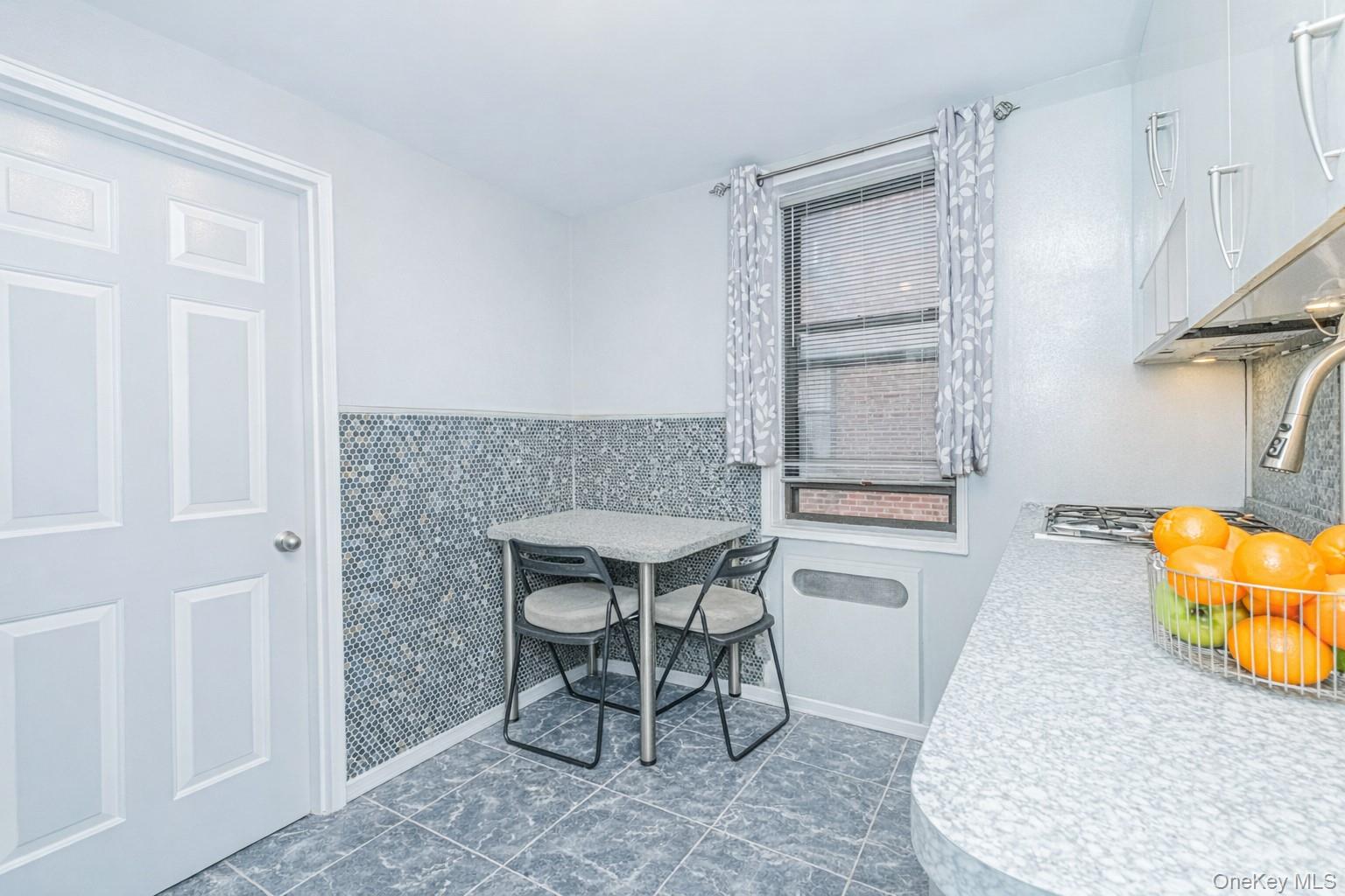 2400 East 3rd Street, Unit 607 Brooklyn, NY 11223 - Photo 12 of 21 a dining room with furniture and a window