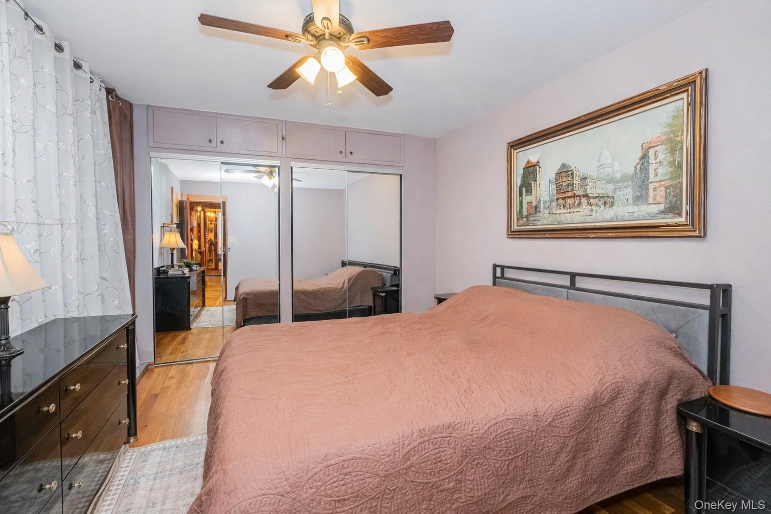 2400 East 3rd Street, Unit 607 Brooklyn, NY 11223 - Photo 15 of 21 a bedroom with a bed and a chandelier