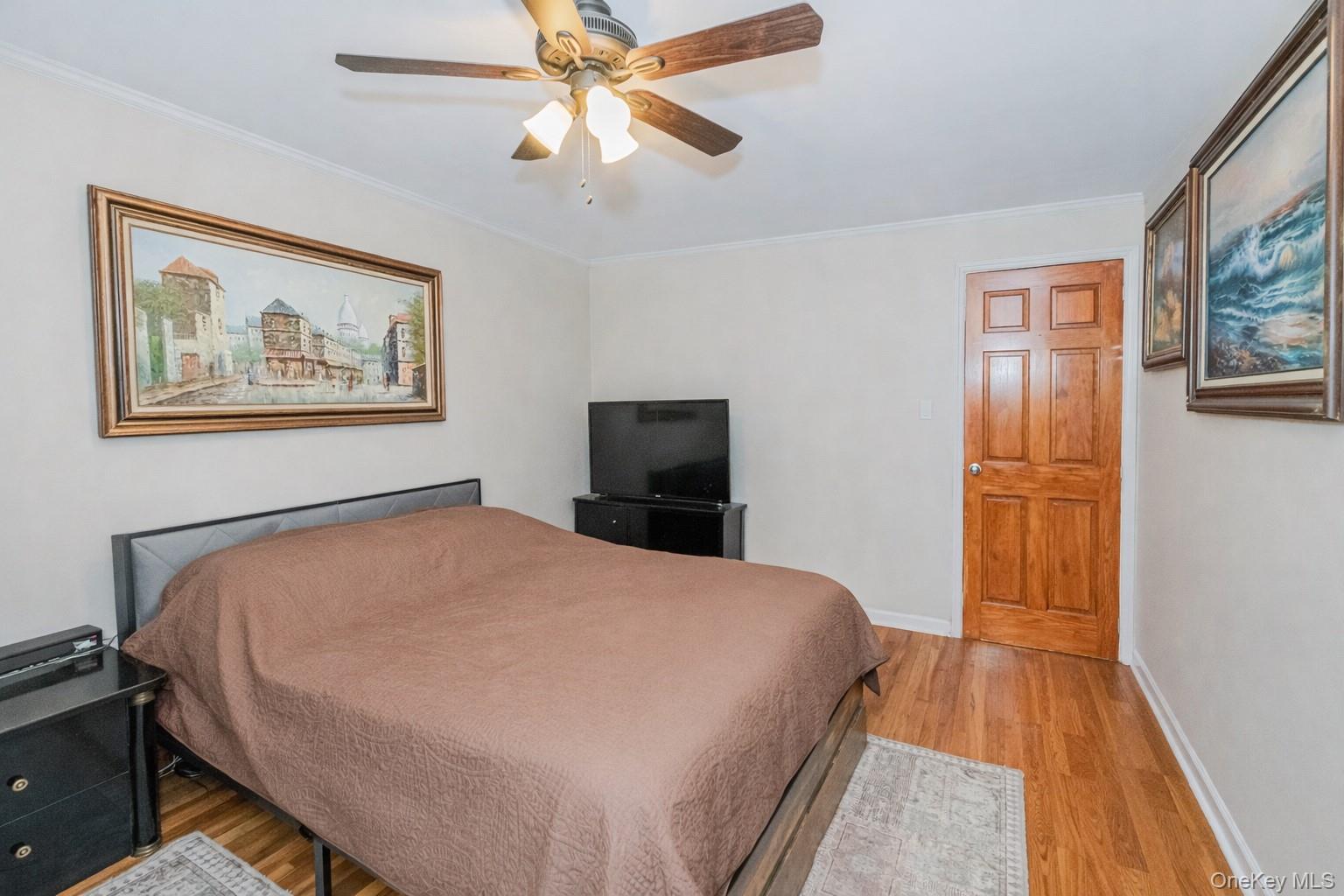 2400 East 3rd Street, Unit 607 Brooklyn, NY 11223 - Photo 16 of 21 a bedroom with a bed and wooden floor