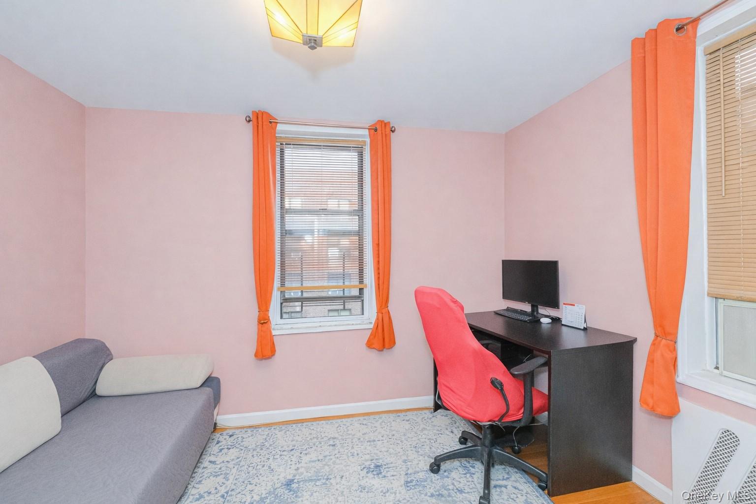 2400 East 3rd Street, Unit 607 Brooklyn, NY 11223 - Photo 17 of 21 a living room with furniture a flat screen tv and a window