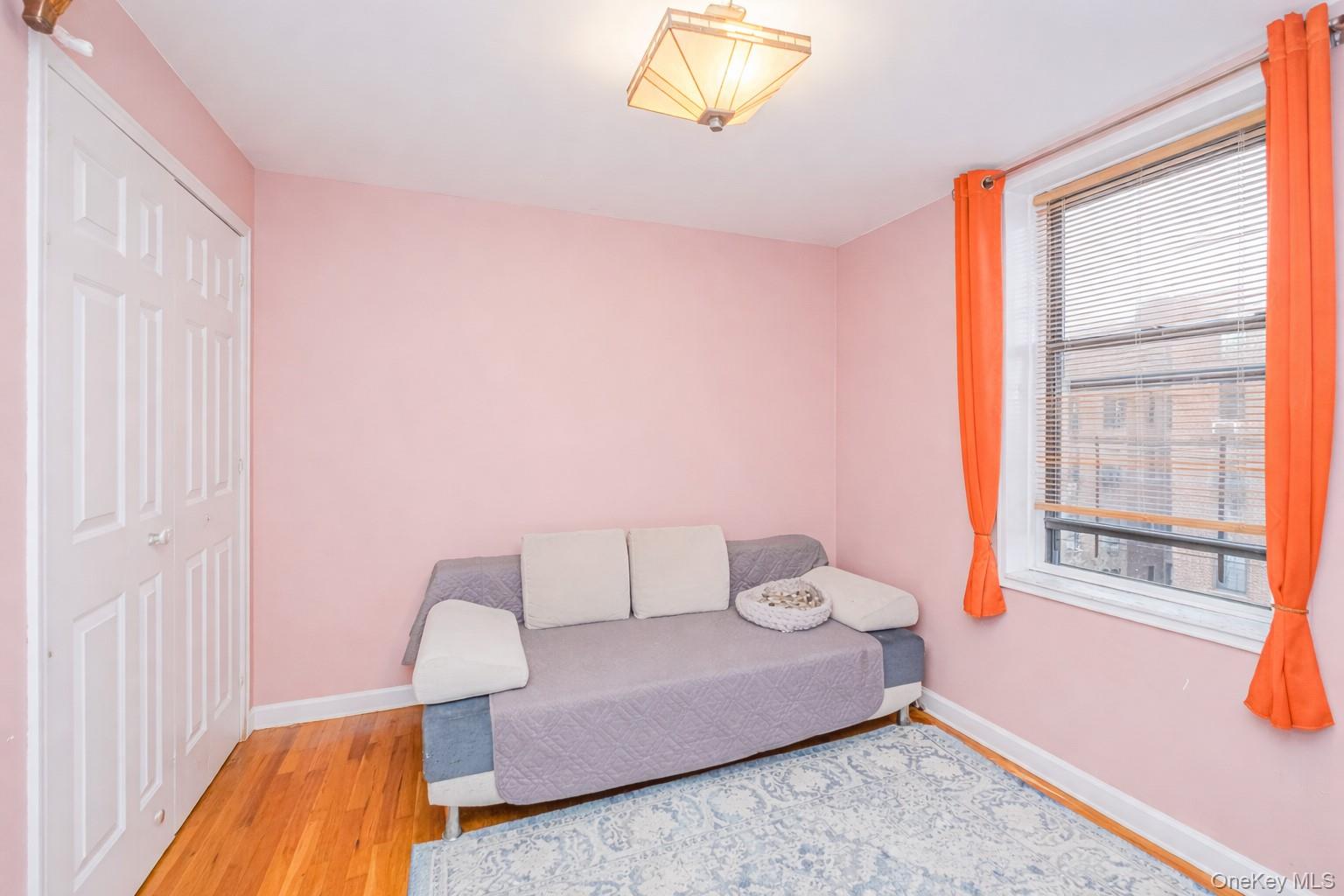 2400 East 3rd Street, Unit 607 Brooklyn, NY 11223 - Photo 18 of 21 a bedroom with a bed and wooden floor