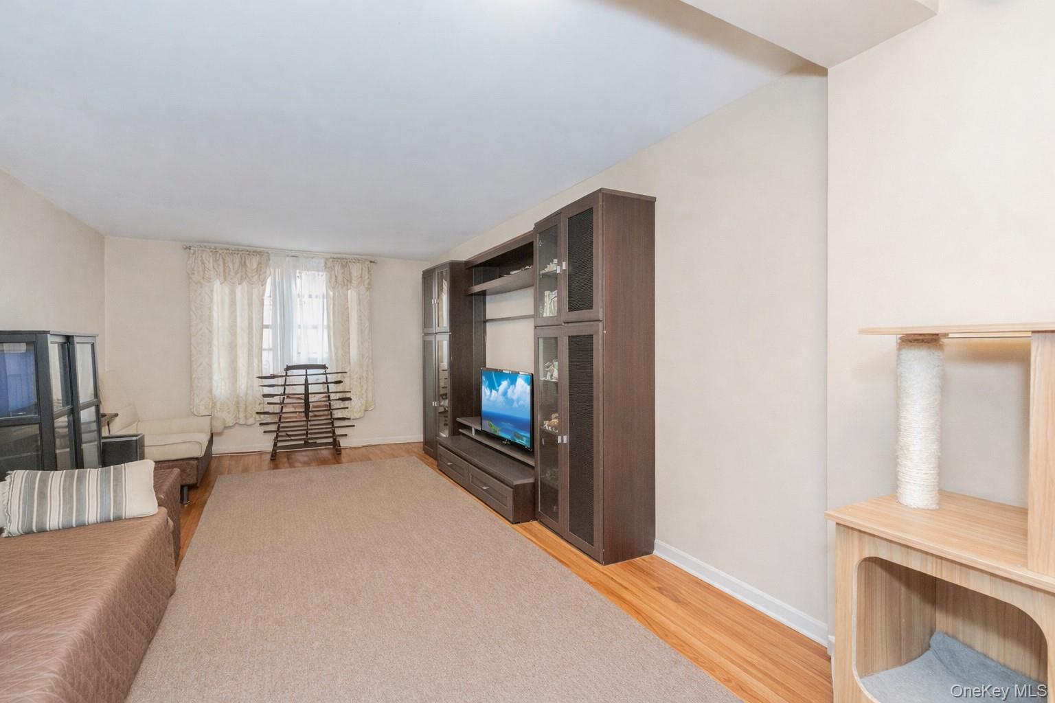 2400 East 3rd Street, Unit 607 Brooklyn, NY 11223 - Photo 19 of 21 a bedroom with furniture and a flat tv screen