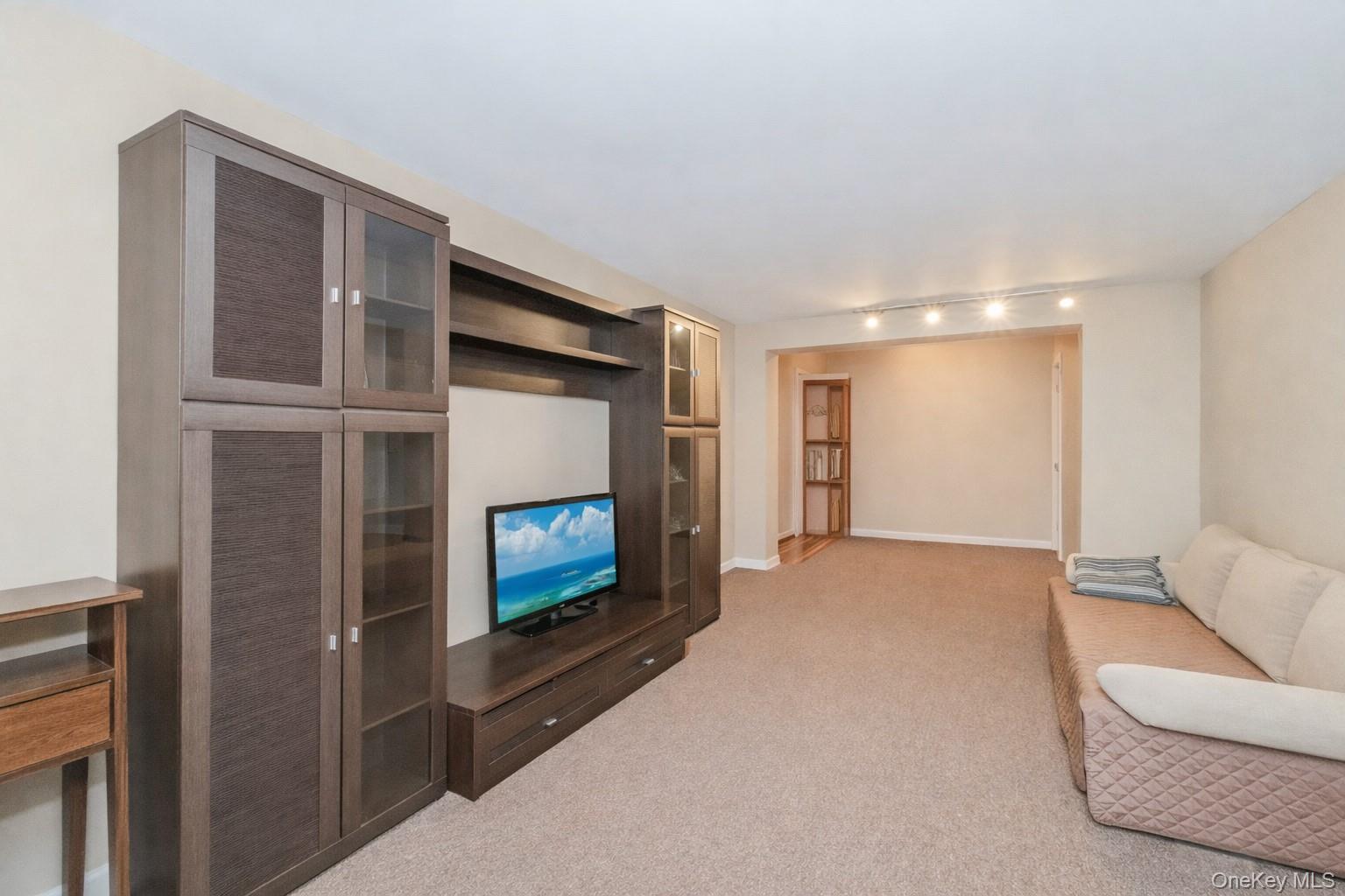 2400 East 3rd Street, Unit 607 Brooklyn, NY 11223 - Photo 20 of 21 a living room with furniture and a fireplace