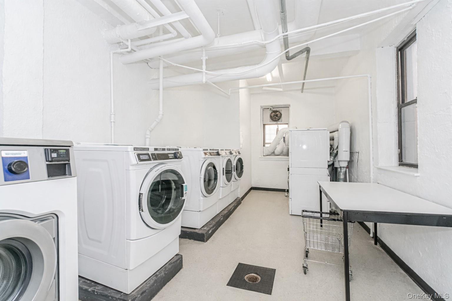 2400 East 3rd Street, Unit 607 Brooklyn, NY 11223 - Photo 6 of 21 a utility room with dryer and washer