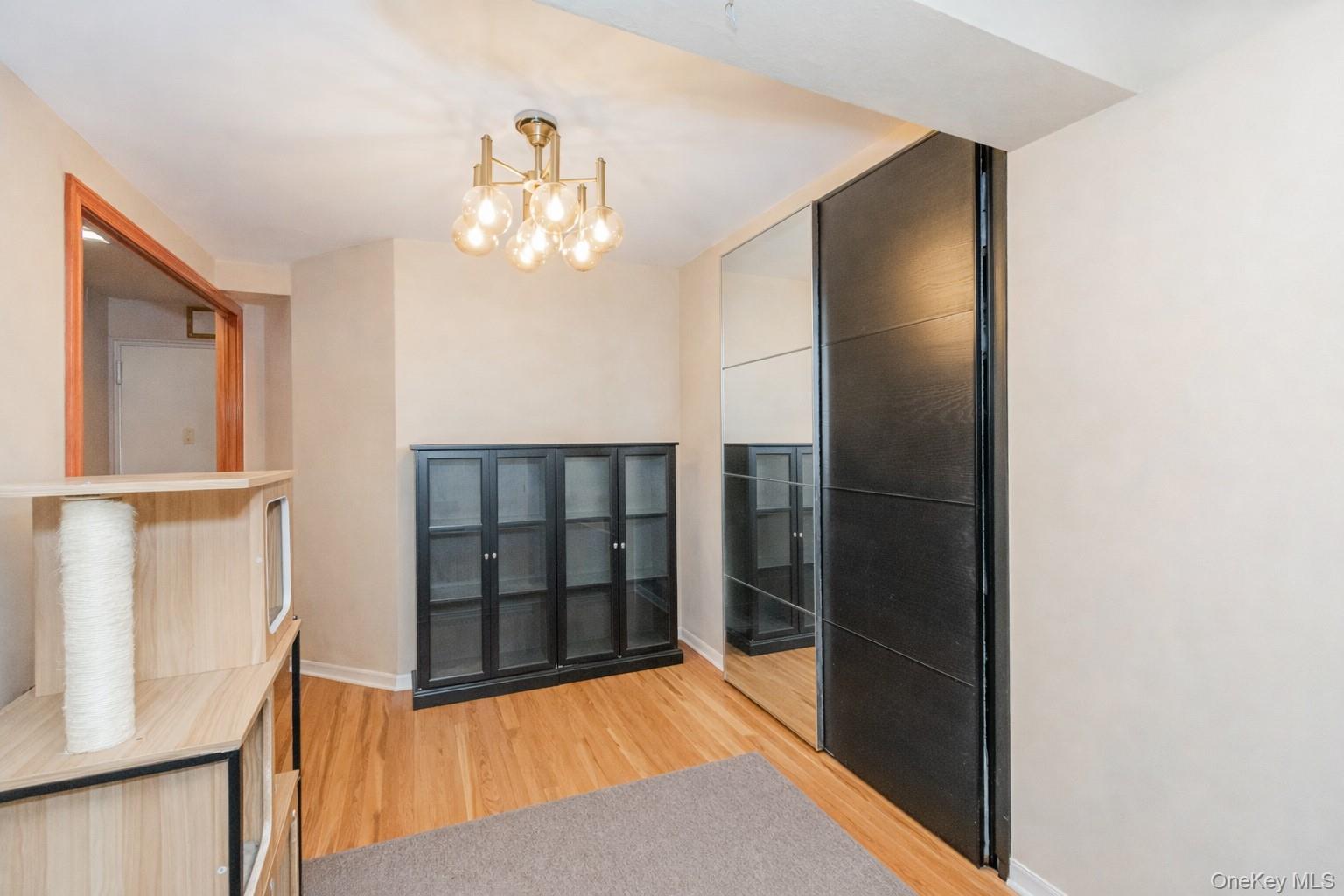 2400 East 3rd Street, Unit 607 Brooklyn, NY 11223 - Photo 9 of 21 a view of a hallway with wooden floor and staircase