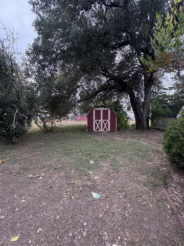 a view of a outdoor space with deck and tree