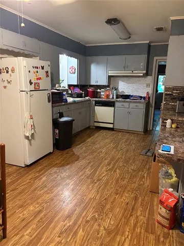 a kitchen with refrigerator and cabinets