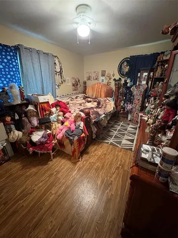 a bedroom with furniture and a wooden floor