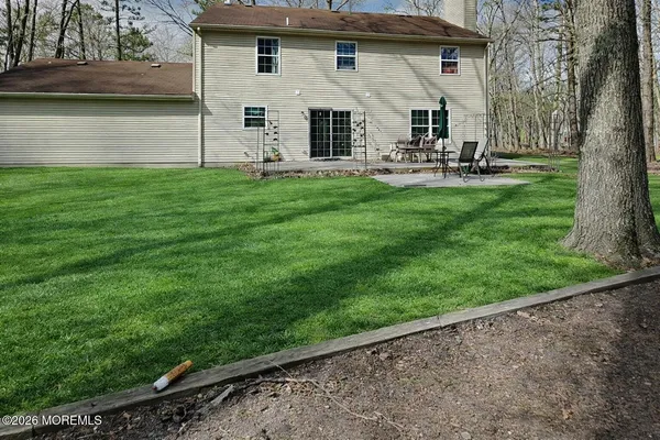 a view of a house with a yard and sitting area
