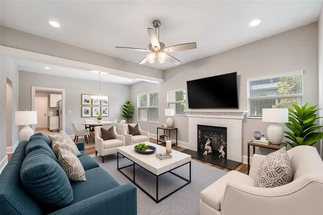 a living room with furniture a fireplace and a flat screen tv