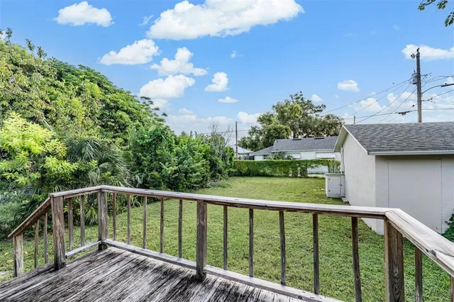 a view of a balcony with wooden floor