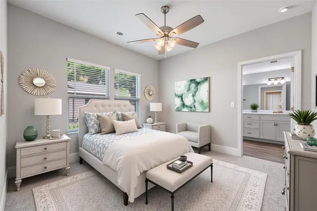 a bedroom with a bed couches and white walls