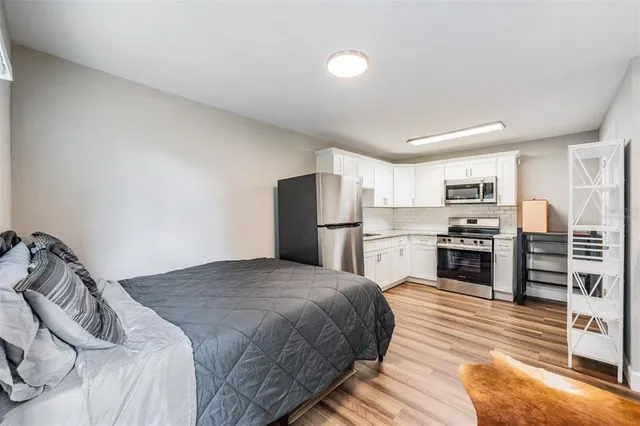 a kitchen with granite countertop a refrigerator stove and oven