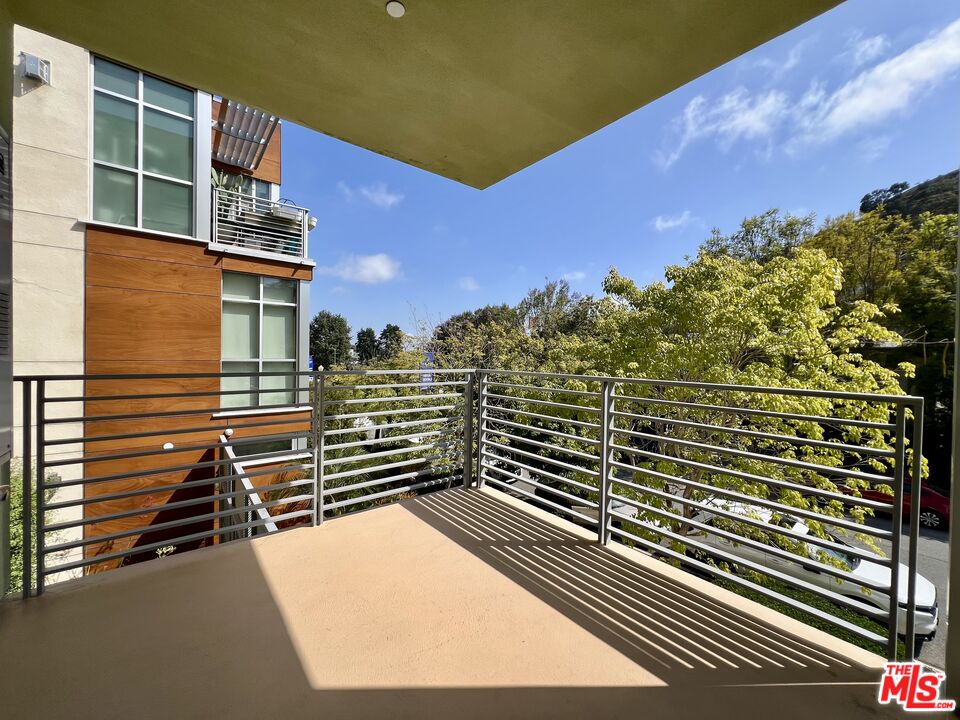 11715 Bellagio Road, Unit 204 Los Angeles, CA 90049 - Photo 17 of 27 a view of a balcony with an outdoor space