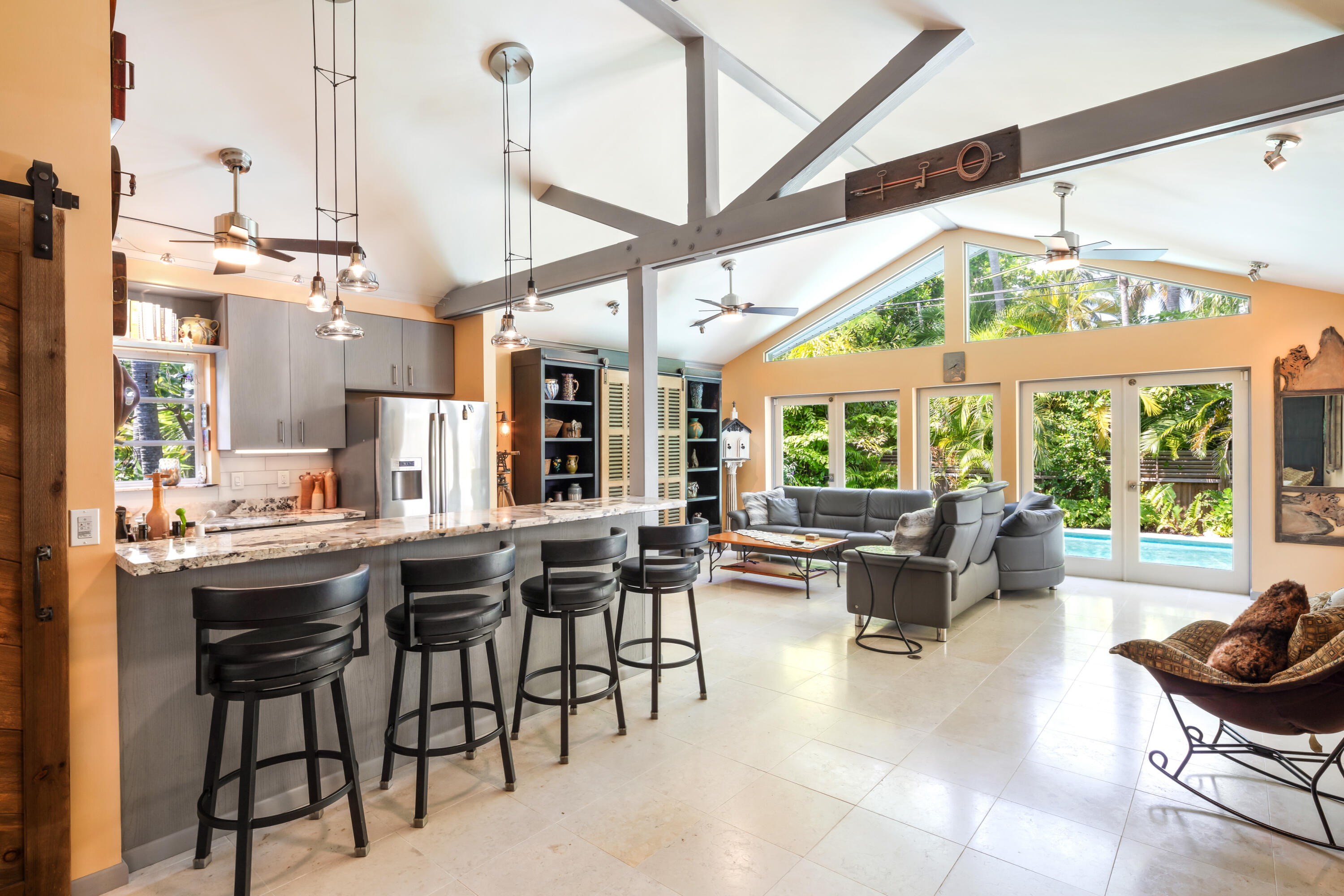 a view of a dining room with furniture large windows and wooden floor