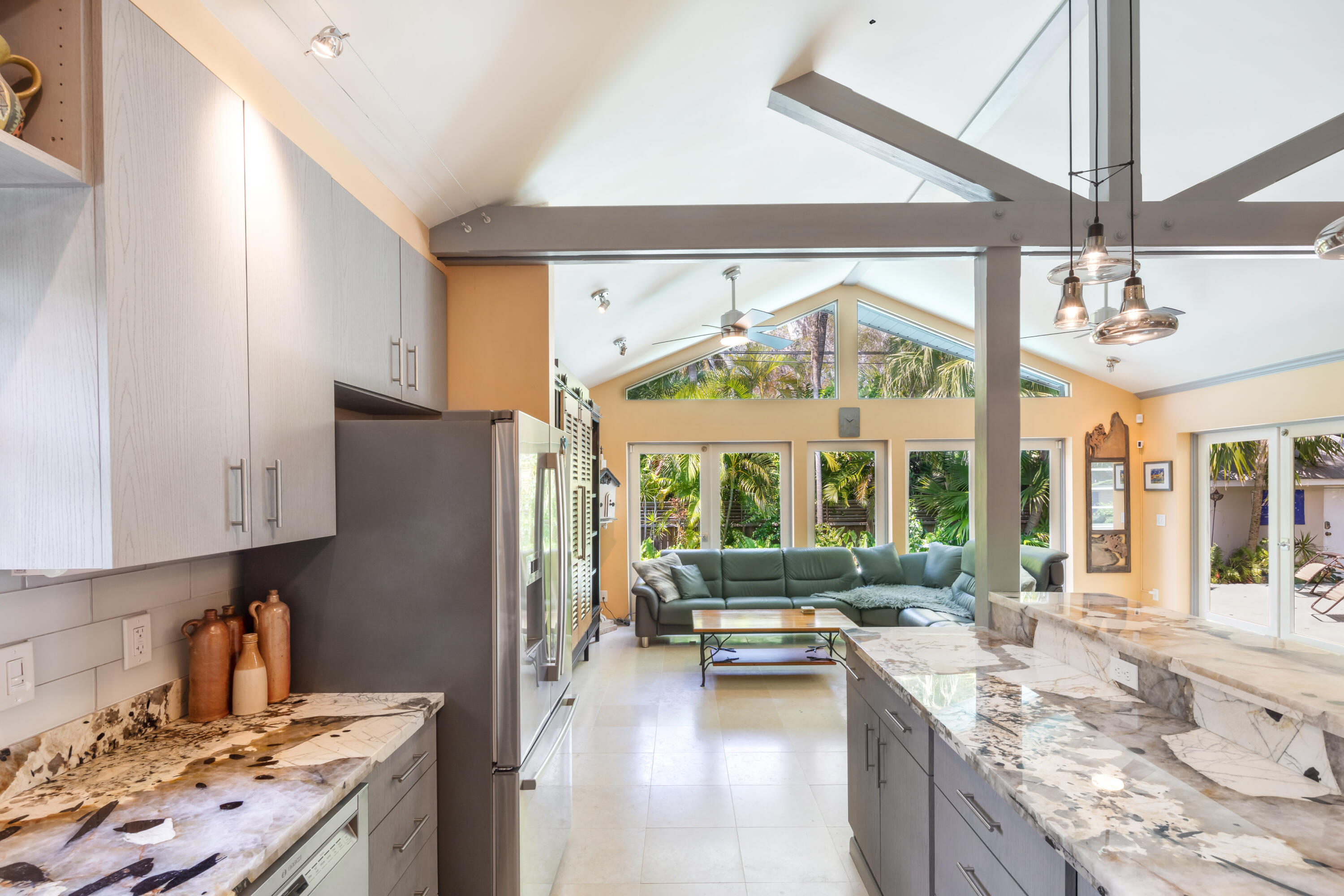 1501 Laird Street Key West, FL 33040 - Photo 18 of 40 a kitchen with a refrigerator a stove and a sink with couches
