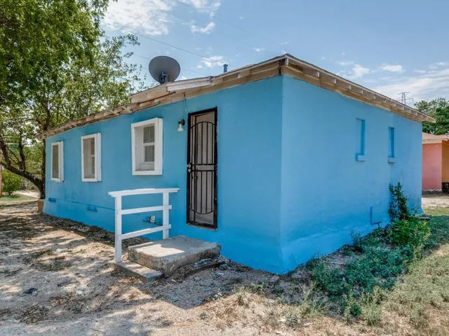 a front view of a house with plants