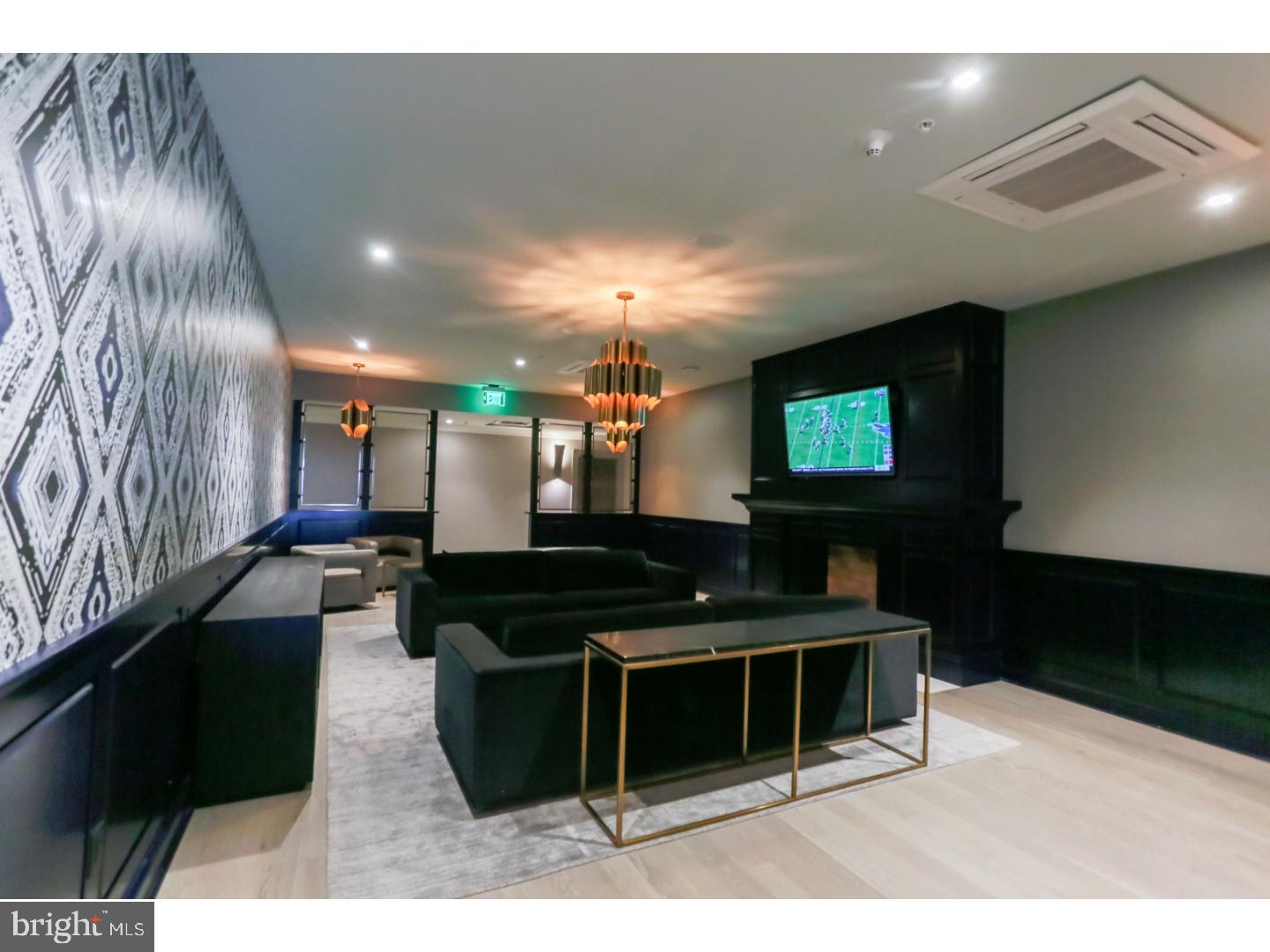 200 North 16th Street, Unit 1402 Philadelphia, PA 19102 - Photo 13 of 21 a lobby with furniture and a flat screen tv
