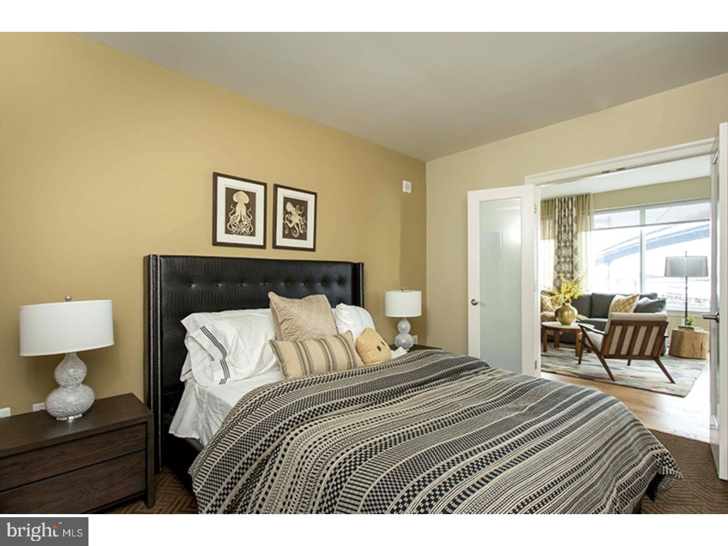 200 North 16th Street, Unit 1402 Philadelphia, PA 19102 - Photo 20 of 21 a bedroom with a bed and wooden floor