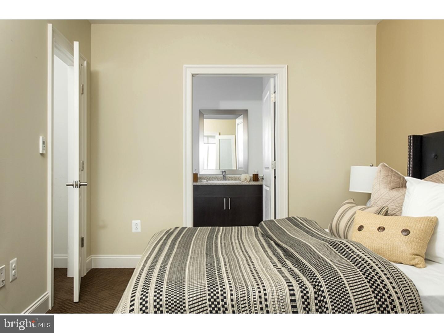 200 North 16th Street, Unit 1402 Philadelphia, PA 19102 - Photo 21 of 21 a bedroom with a bed and a view of bathroom