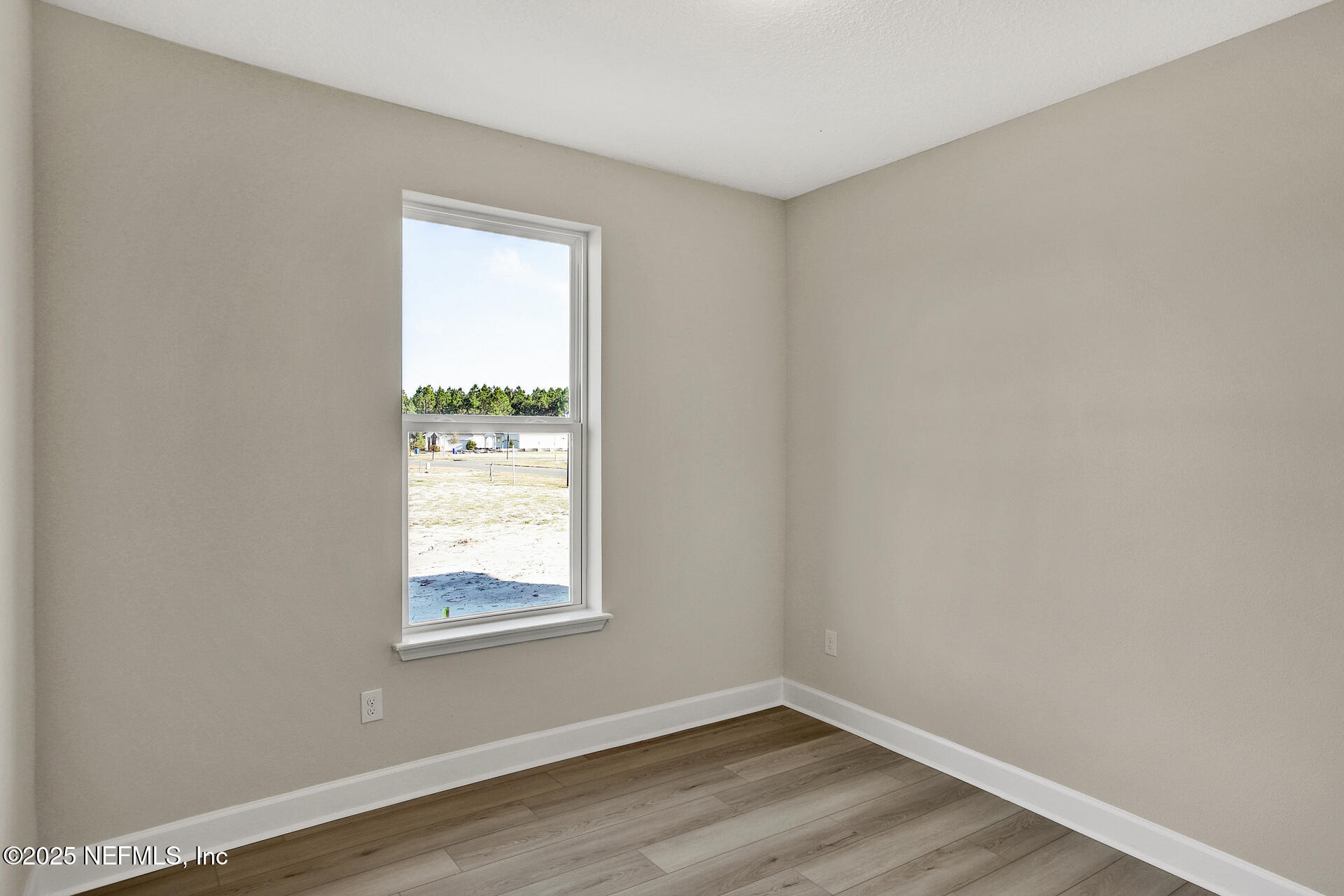 57 Bees Knees Way St. Augustine, FL 32092 - Photo 11 of 20 a view of an empty room with wooden floor and a window