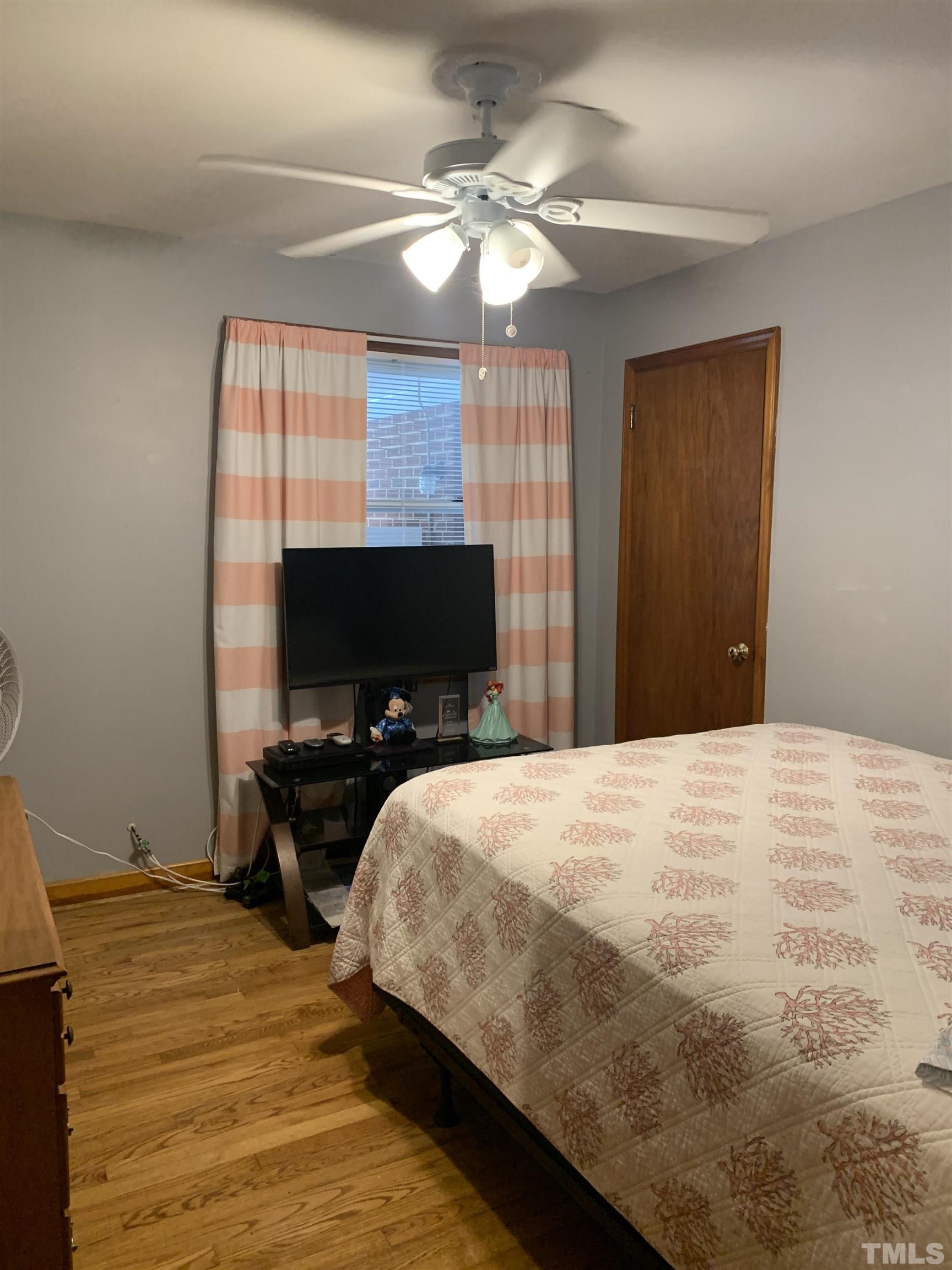 2804 Sparger Road Durham, NC 27705 - Photo 11 of 34 a bedroom with a bed and a flat screen tv