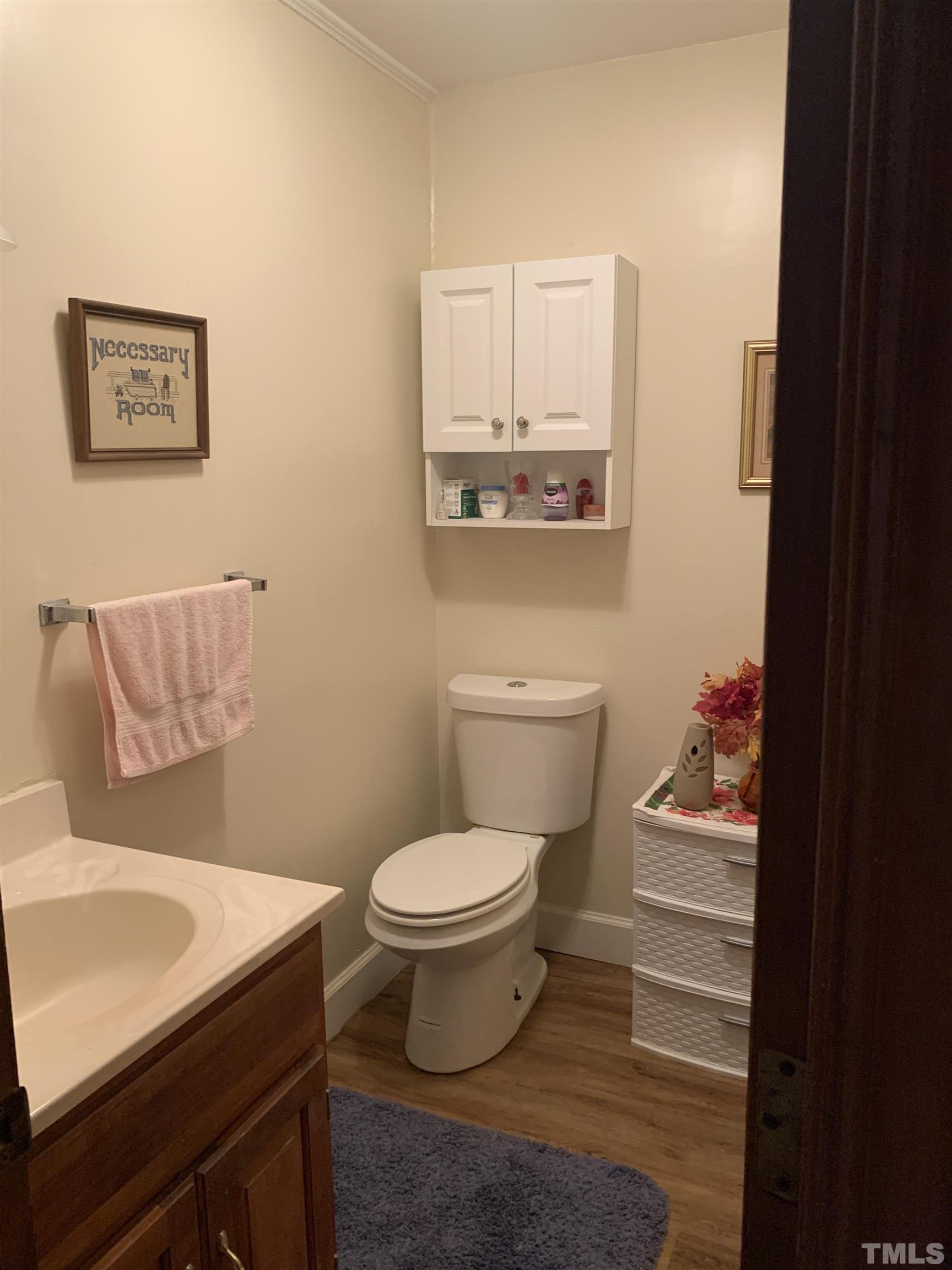 2804 Sparger Road Durham, NC 27705 - Photo 13 of 34 a bathroom with a toilet sink and mirror