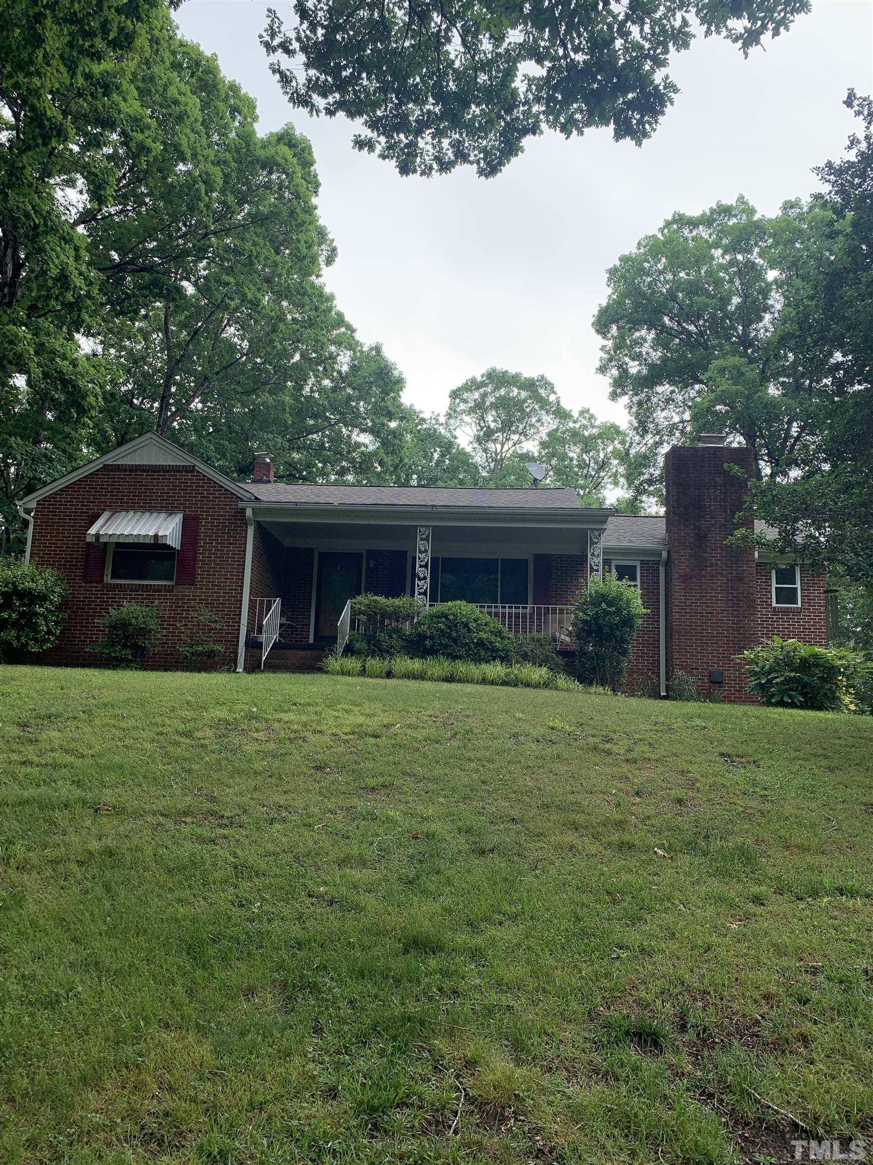 2804 Sparger Road Durham, NC 27705 - Photo 17 of 34 a front view of a house with a garden and yard
