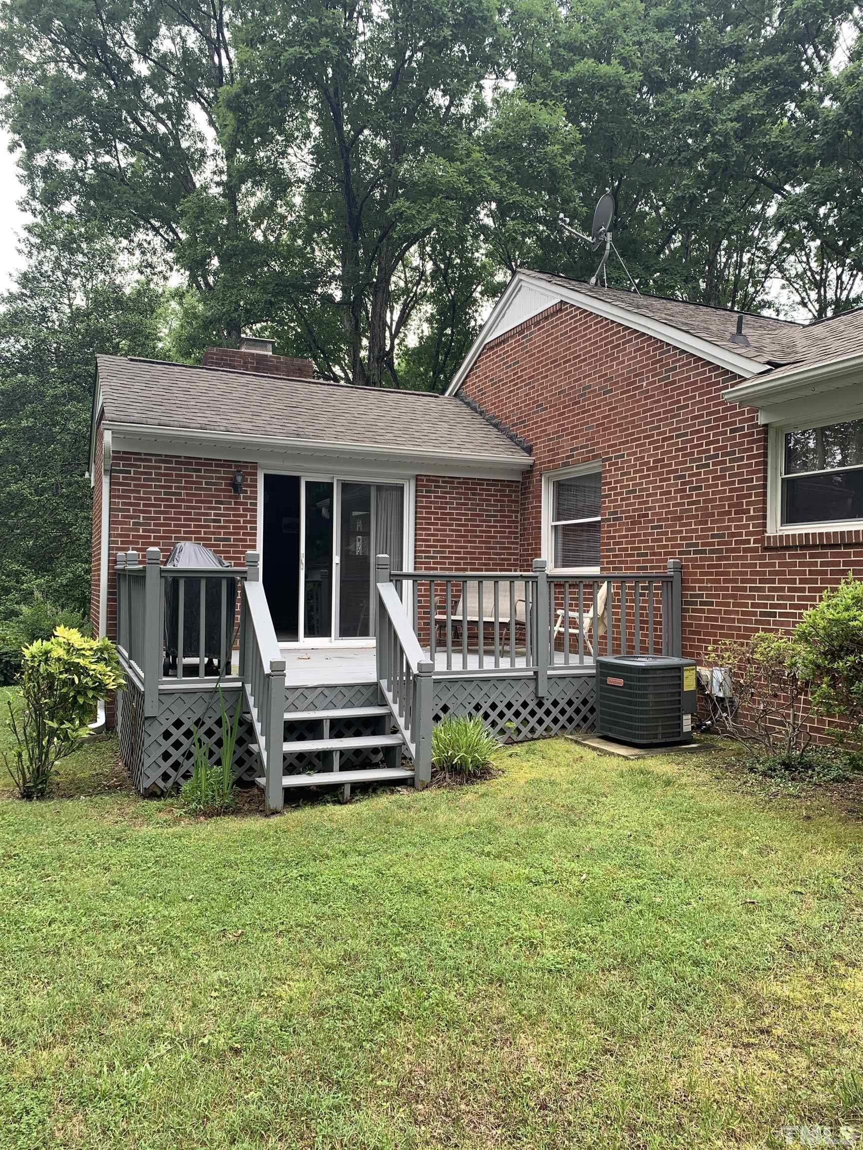 2804 Sparger Road Durham, NC 27705 - Photo 18 of 34 a view of a house with backyard sitting area and garden
