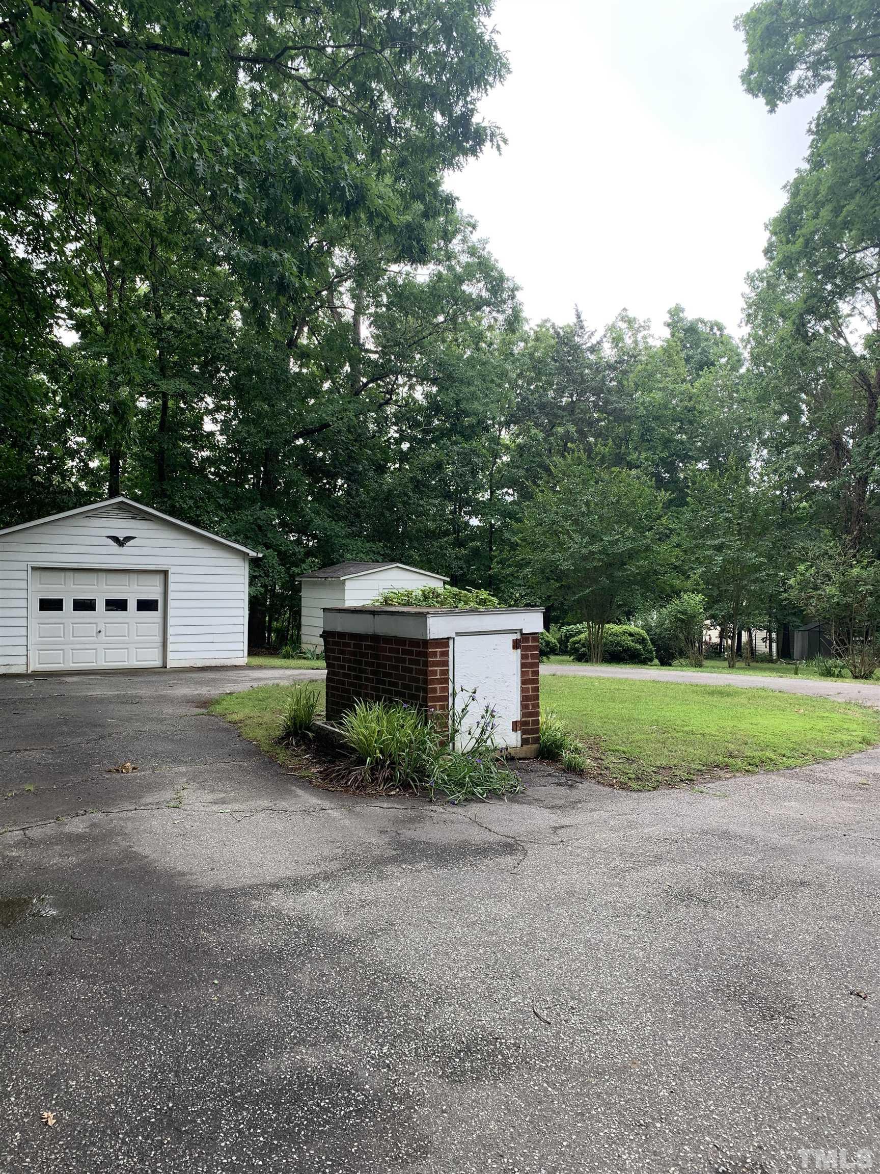 2804 Sparger Road Durham, NC 27705 - Photo 20 of 34 a view of backyard with a barn and large trees