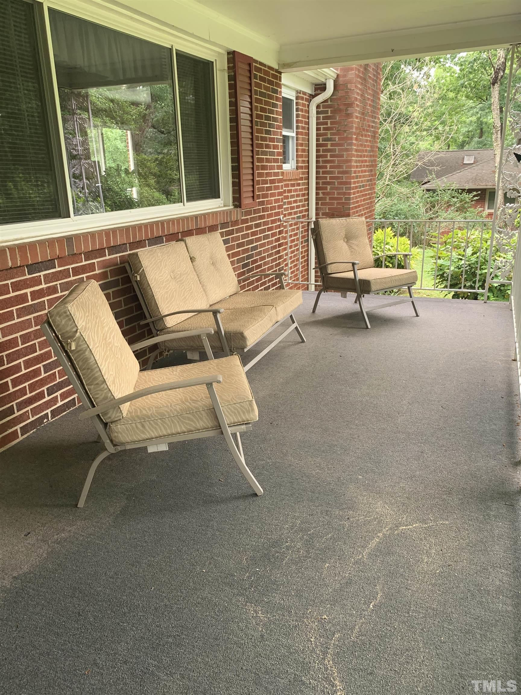 2804 Sparger Road Durham, NC 27705 - Photo 2 of 34 a balcony with couple of chairs and a couch
