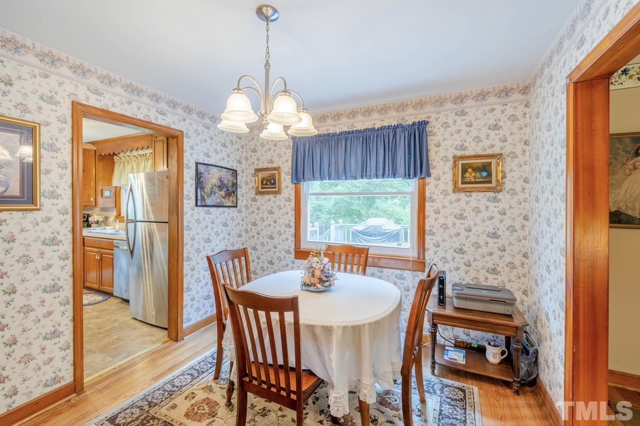 2804 Sparger Road Durham, NC 27705 - Photo 22 of 34 a dining room with furniture a chandelier and window