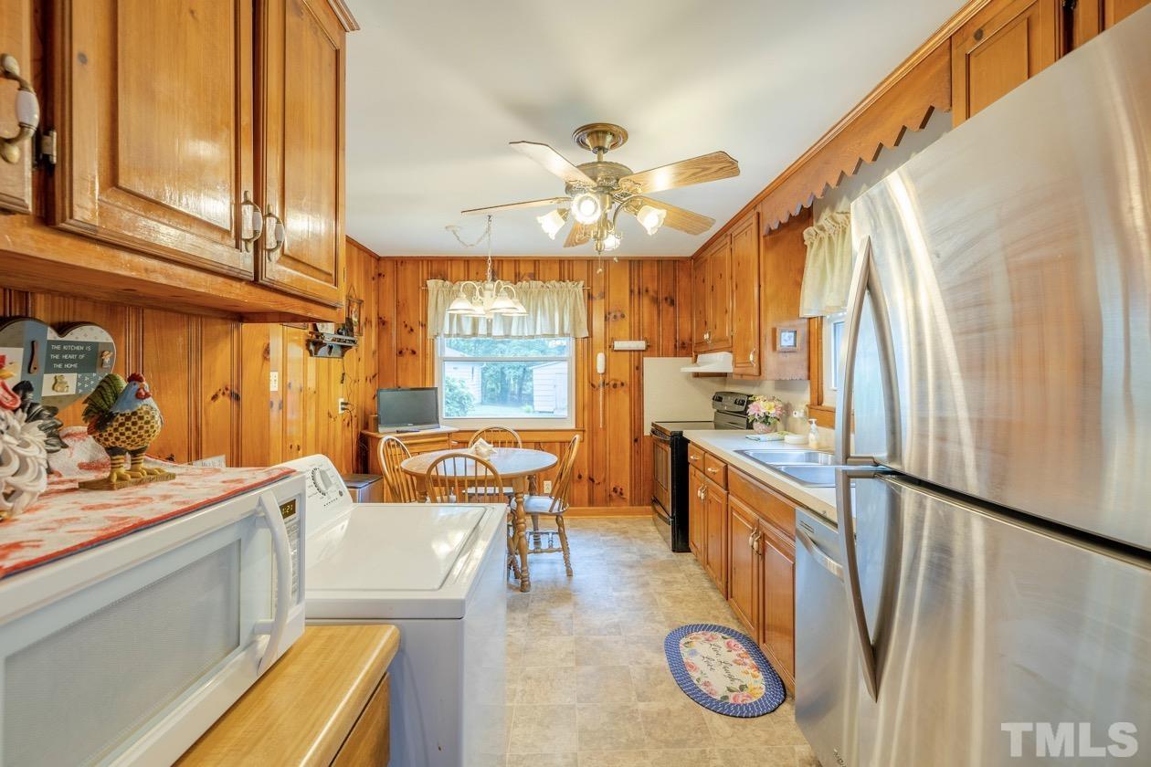 2804 Sparger Road Durham, NC 27705 - Photo 23 of 34 a kitchen with stainless steel appliances granite countertop sink stove top oven and cabinets