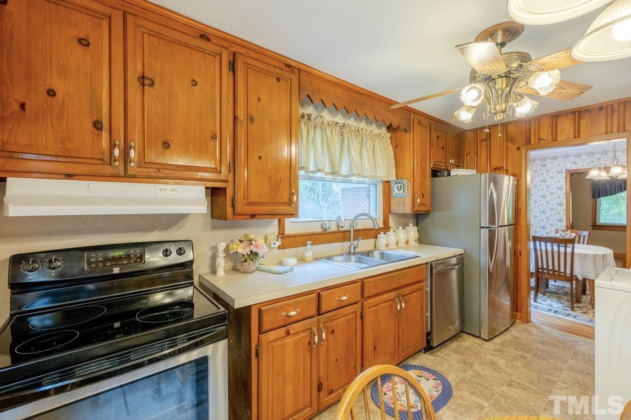 2804 Sparger Road Durham, NC 27705 - Photo 25 of 34 a kitchen with a stove a sink and a refrigerator