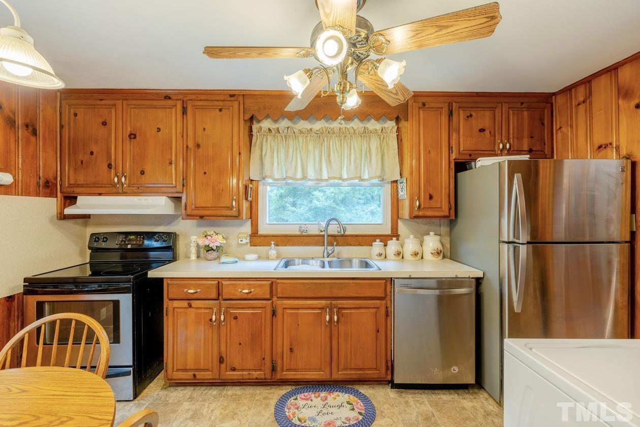 2804 Sparger Road Durham, NC 27705 - Photo 26 of 34 a kitchen with a refrigerator a stove top oven a sink and dishwasher