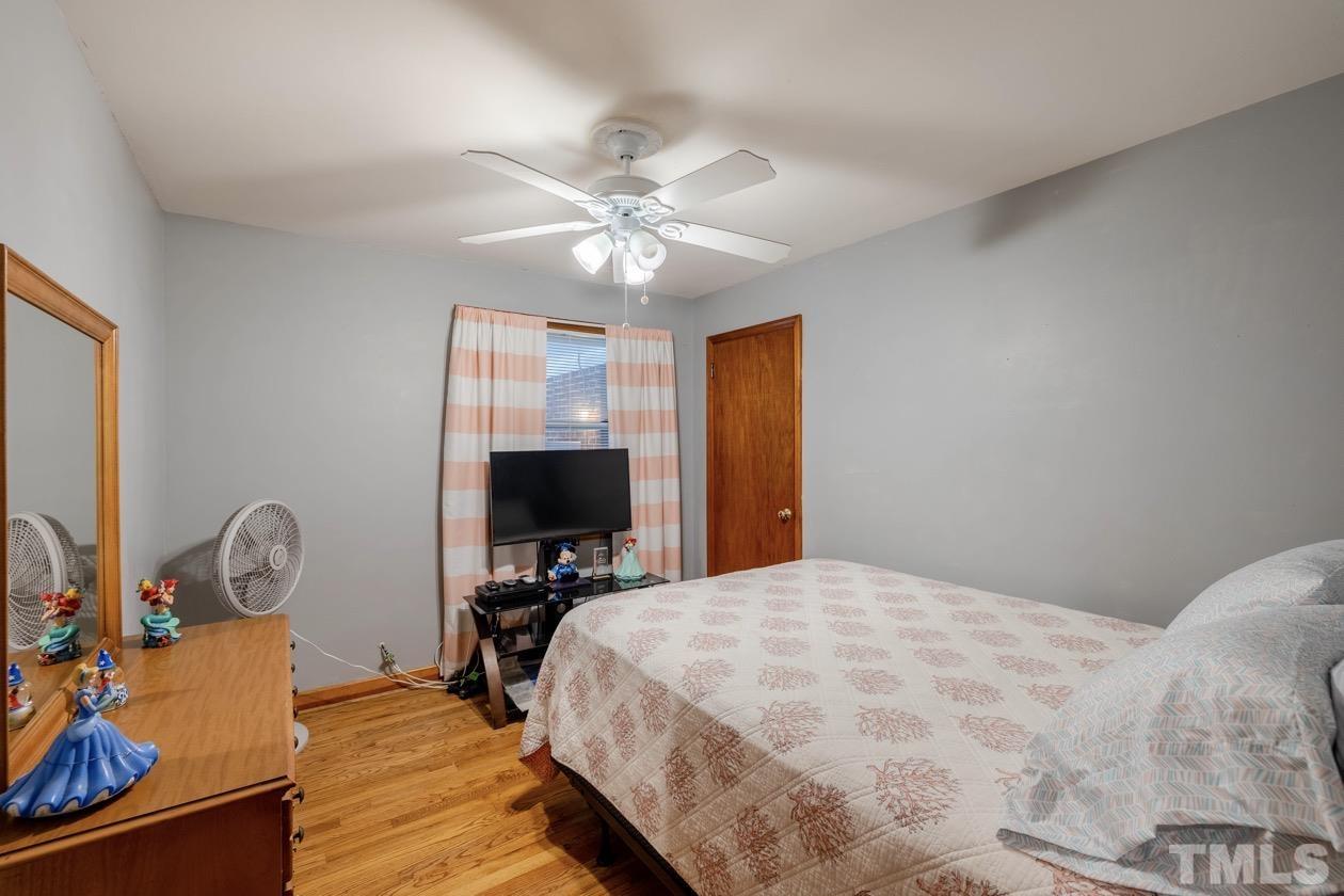 2804 Sparger Road Durham, NC 27705 - Photo 29 of 34 a bedroom with a bed and a flat screen tv