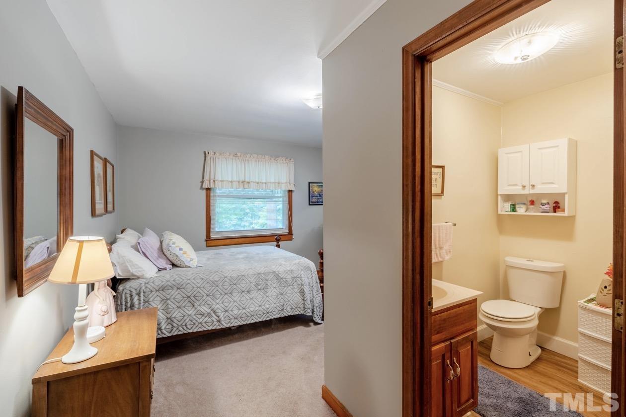 2804 Sparger Road Durham, NC 27705 - Photo 32 of 34 a bedroom with a bed and a couch