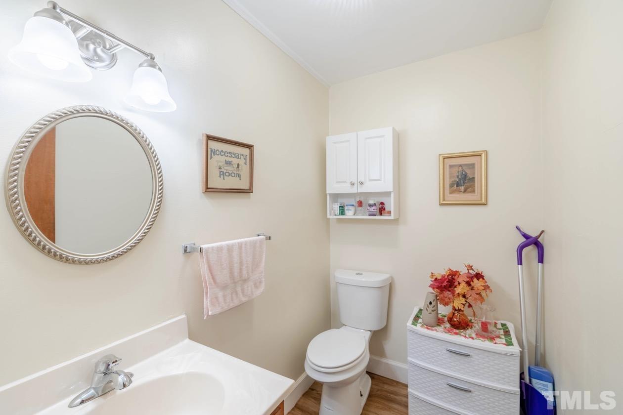 2804 Sparger Road Durham, NC 27705 - Photo 33 of 34 a bathroom with a toilet a sink and a mirror