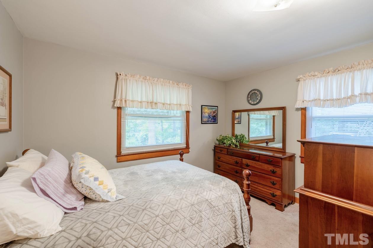 2804 Sparger Road Durham, NC 27705 - Photo 34 of 34 a bedroom with a bed and dresser with mirror